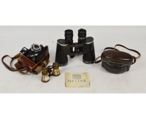 A cased Zeiss Ikon camera, a Dacora camera, a pair of WWII military US Navy binoculars, and a pair of French opera glasses (4