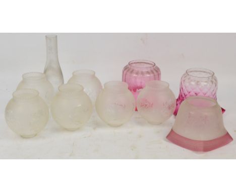 Three cranberry tinted late Victorian/Edwardian oil lamp shades, a single glass chimney, and a set of six mid 20th century et