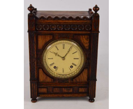 WINTERHALDER & HOFMEIER; a carved Black Forest oak eight day striking mantel clock, the circular brass dial set with Roman nu