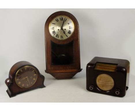 A 1940s oak wall clock with silvered dial set with Roman numerals, a mantel clock and a brown bakelite Bush radio (3).