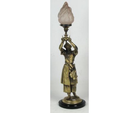 A gilt metal figural lamp base, modelled as a gentleman in Eastern clothing, raised on circular base and ebonised pedestal, w