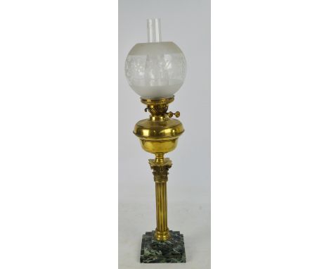 A brass Corinthian column oil lamp with etched globular shade and stepped marble plinth, height including chimney 78cm.