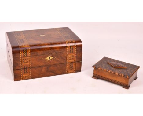 A late Victorian walnut and inlaid writing slope with mother of pearl lozenge shaped escutcheon, the lid enclosing fitted int