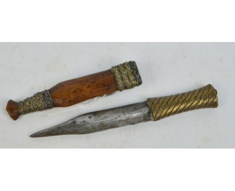 An interesting 19th century double edged dagger with brass strapwork grip, and wooden scabbard with integral loop attachment,