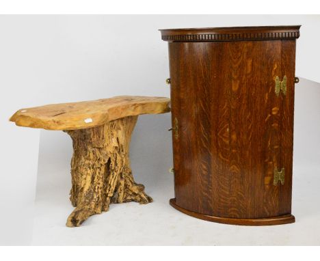 An oak bowfronted corner cupboard, height 67cm, and a tree trunk stool (2).