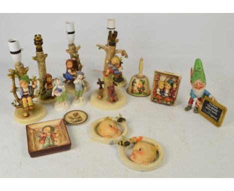 A quantity of Goebel Hummel including five lamp bases, a gnome holding a plaque inscribed "The Merry Co-Boys...", two glazed 