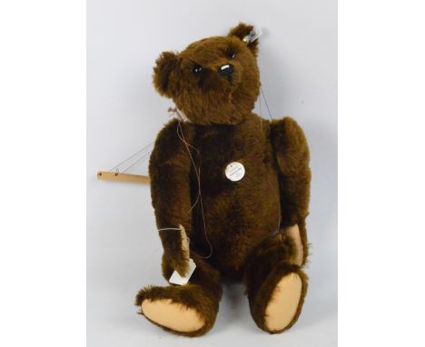 A boxed Steiff Pantom teddy bear 1910, no.406614, with numbered white and black tag to ear, with dark brown mohair fur and pu