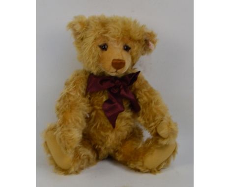 A boxed Steiff 2000 Millennium teddy bear no.670374, with numbered white and red tag to ear, with curly blonde mohair fur and