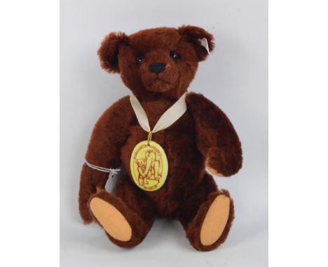 A boxed Margarete Steiff Museum teddy 1999, no.670343, with numbered white and red tag to ear, with reddish brown mohair fur 