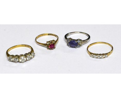 A 9ct yellow gold dress ring set with a ruby surrounded by four clear stones, size N, a 9ct yellow gold five stone ring with 