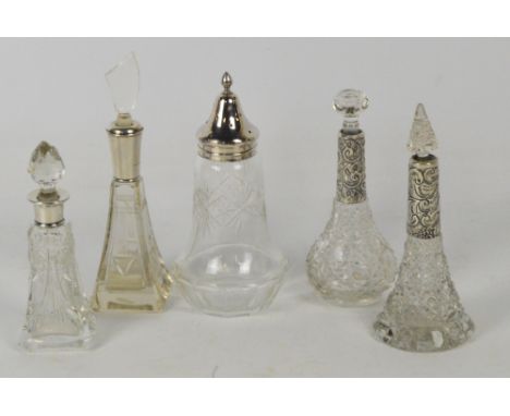 A collection of glass scent bottles with hallmarked silver collars comprising an Art Deco type pyramid shaped example, Willia