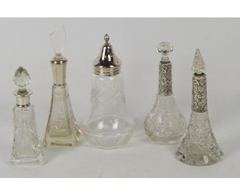 A collection of glass scent bottles with hallmarked silver collars comprising an Art Deco type pyramid shaped example, Willia