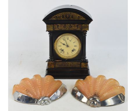 A c.1900 ebonised mantel clock, the circular dial set with Roman numerals flanked by pilasters to a stepped base, height 39cm