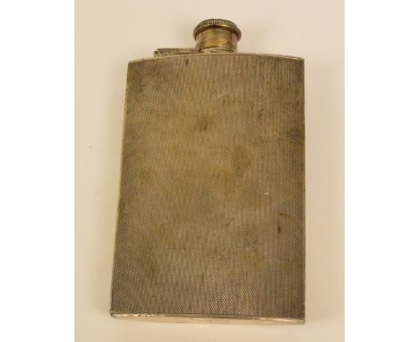 A George VI hallmarked silver hip flask of rectangular form with overall engine turned decoration and with hinged screw cap, 