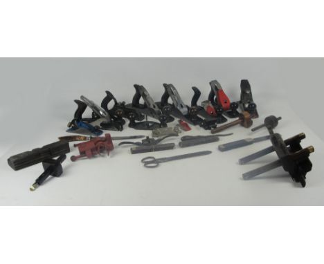 A large collection of woodworking tools including a 1930s grooving plane with brass mounts, a 1940s rosewood and brass inlaid