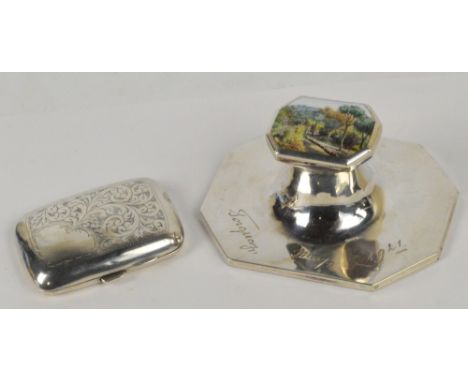 A George V hallmarked silver inkwell with spreading octagonal base inscribed "Torquay May 1921", the shaped hinged lid set wi