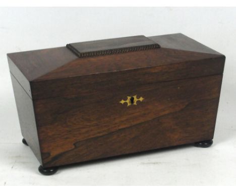 An early Victorian rosewood sarcophagus tea caddy, the hinged lid enclosing three section interior with two lidded containers