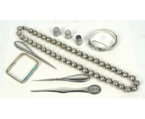 A quantity of silver items comprising a Mexican silver bead necklace, a snap bangle with floral engraved decoration, a furthe