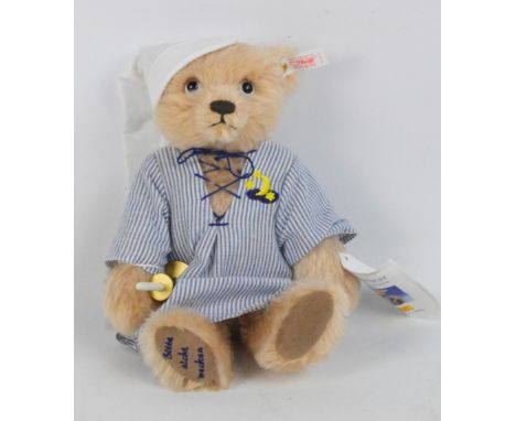 A Steiff Bedtime teddy bear no.670510, with numbered white and red tag to ear, with pale blonde mohair fur, wearing nightshir