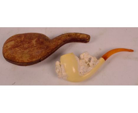 A cased unused late 19th century carved Meerschaum pipe, the front of the bowl decorated with two figures seated holding thei