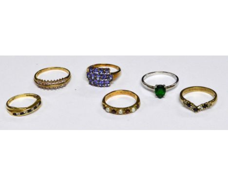 A collection of 9ct yellow gold dress rings comprising an example with a panel of mauve stones, size N/O, a wishbone ring wit