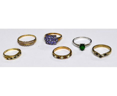 A collection of 9ct yellow gold dress rings comprising an example with a panel of mauve stones, size N/O, a wishbone ring wit