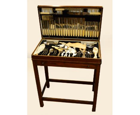 A 1940s oak table canteen of electroplated cutlery comprising dinner forks, dessert forks, soup forks, dessert spoons, ivorin