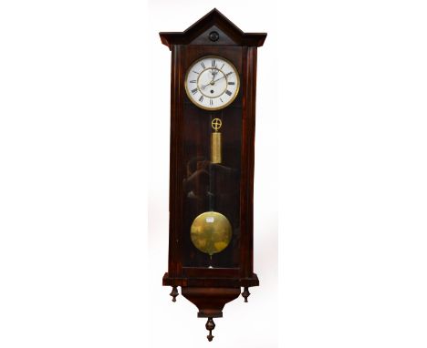 A Biedermeier stained beech single weight wall clock with arched pediment above white enamel dial and glazed door, length 110