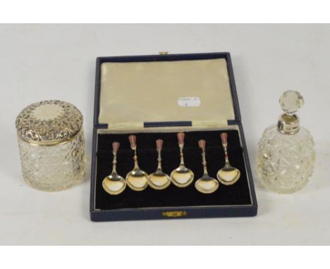 A cased set of six Elizabeth II hallmarked silver gilt coffee spoons with enamel decoration to the back of bowl, stem and fin