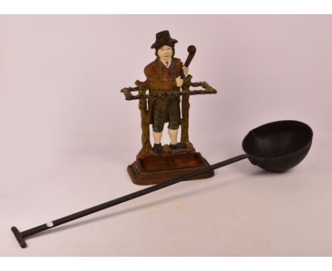 A wrought iron polychrome umbrella stand, height 51.5cm, and a very large black painted wrought iron ladle, diameter of the o