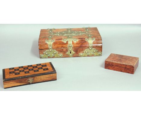 VICTORIAN WALNUT AND BRASS BOUND GAMES BOX, the cover with playing card decoration, the fitted interior with various bone and