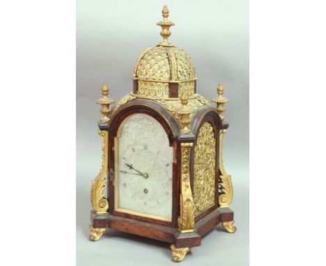 VICTORIAN WALNUT AND GILT BRASS MOUNTED MANTEL CLOCK, the arched silvered 5 1/2" dial with scrolling foliate decoration, insc