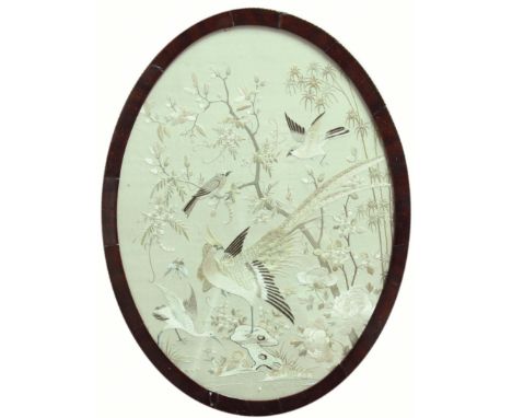 GEORGE III SILKWORK PANEL, circa 1800, the oval image of an exotic pheasant, other birds and insects among foliage, 38.5cm x 