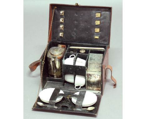 LEATHER CASED TRAVELLING PICNIC SET, retailed by Barrett & Sons, comprising a silver plated kettle and burner, three canister