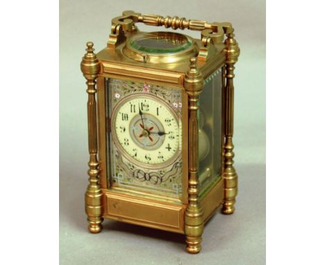 BRASS FOUR PANE CARRIAGE CLOCK, the ivorine chapter ring inside a floral enamelled frame, on a brass eight day, half hourly s