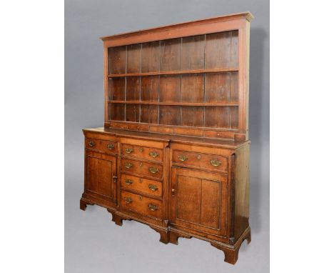 GEORGE III BREAKFRONT DRESSER, the plate rack with a moulded cornice above three shelves and set of five spice drawers, the b