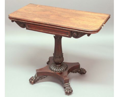 WILLIAM IV ROSEWOOD CARD TABLE, the rounded rectangular, rotating top on a tapering foliate carved column, quadripartite plat