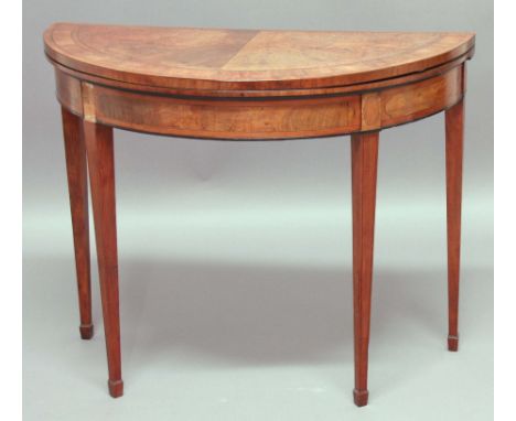 GEORGE III WALNUT DEMI-LUNE FOLD OUT CARD TABLE, the satinwood crossbanded and line inlaid top above a similarly decorated fr