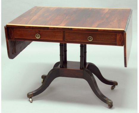 REGENCY ROSEWOOD AND INLAID SOFA TABLE, the satinwood crossbanded top above two true and two faux drawers with brass ring pul