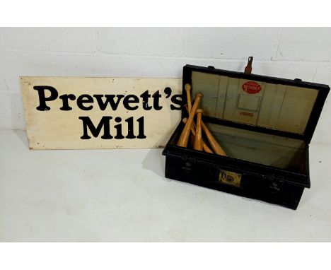 A vintage black tin trunk, a Prewett's mill sign and a collection of vintage gym batons.
