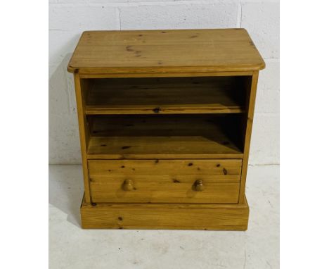 A freestanding pine unit with shelf and single drawer.