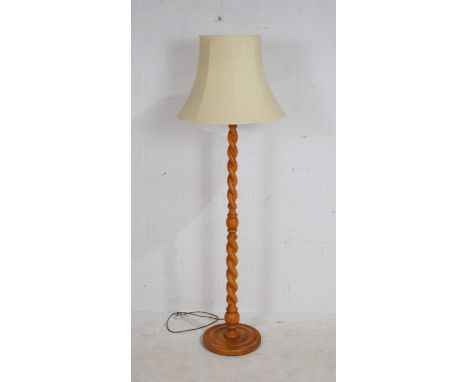 A contemporary barley twist standard lamp, 142 cm high with pale lemon shade.