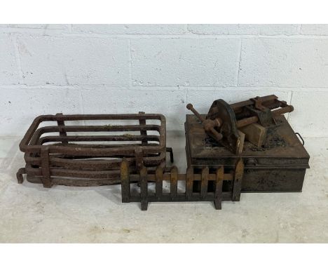 A vintage cast iron fire grate along with a Record No 52 bench vice and a metal box