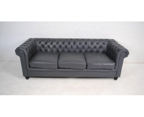 A modern grey leather Chesterfield sofa, raised on turned feet - length 217cm