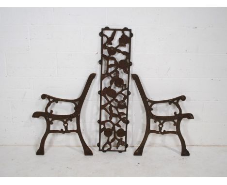 A pair of cast iron garden bench ends and back