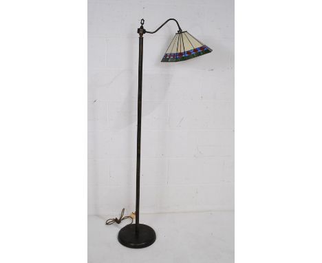 A metal standard lamp, with Tiffany style glass shade - height 149.5cm