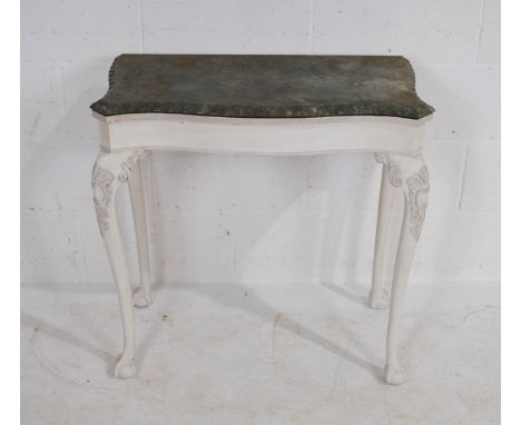 A vintage white painted serpentine-fronted folding card table, with faux marble top with green baize, raised on cabriole legs
