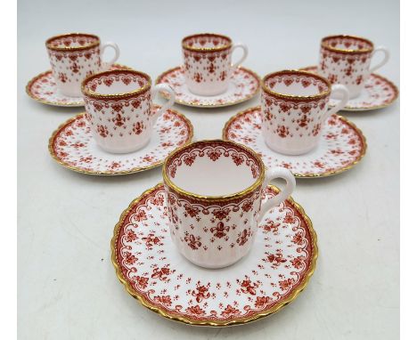 A part Spode red Fleur De Lys pattern coffee set consisting of six coffee cups and saucers.
