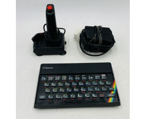 An unboxed vintage Sinclair ZX Spectrum computer console with joystick and power cable - untested