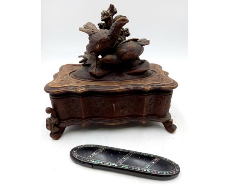 An antique black forest carved wood trinket box, the top carved with a pair of quail and foliage, needs some restoration but 